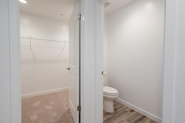 387 Thunder Rd S, Madera, CA 93636 - bathroom with a spacious closet, toilet, wood finished floors, and baseboards