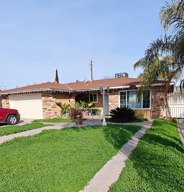 ranch-style house with a garage and a front lawn