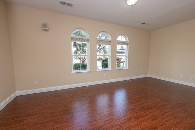 empty room featuring dark hardwood / wood-style flooring