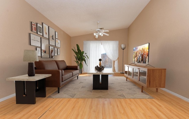 living room with lofted ceiling, a textured ceiling, light hardwood / wood-style flooring, and ceiling fan