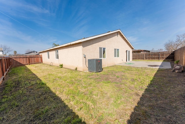 rear view of property with central AC, a patio, and a lawn