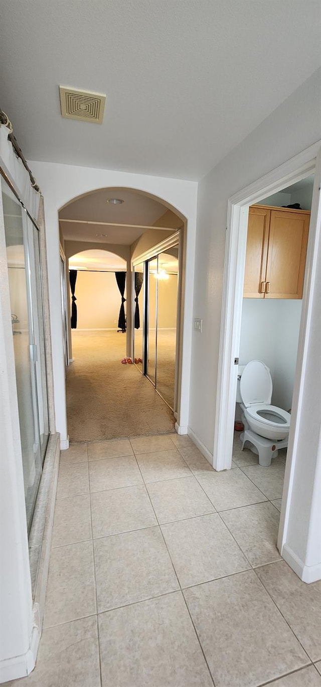 hall with light tile patterned floors