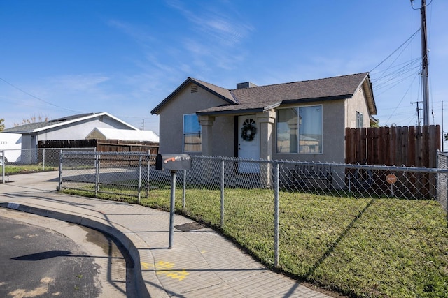 bungalow-style home featuring a front lawn