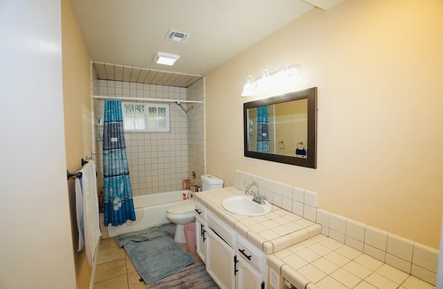 full bathroom with shower / tub combo with curtain, vanity, toilet, and tile patterned flooring