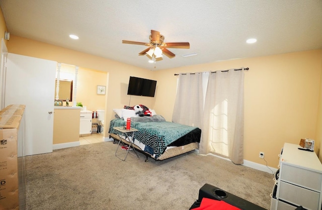 bedroom with ensuite bath and light carpet