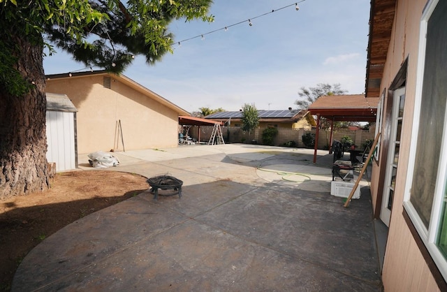 view of patio featuring a gazebo and an outdoor fire pit