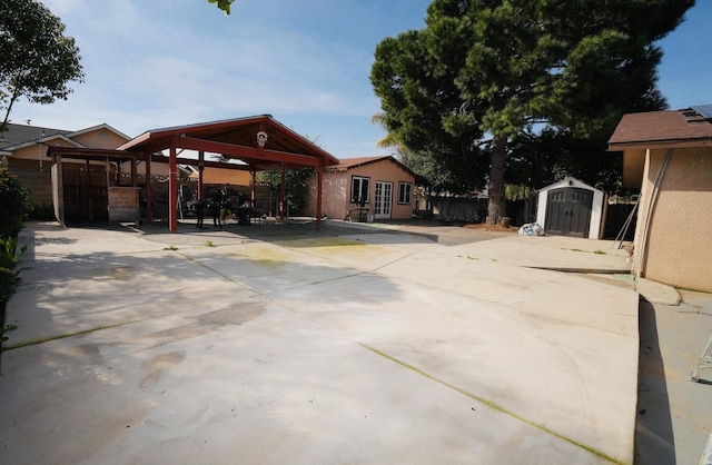 view of patio / terrace with a storage shed and a gazebo