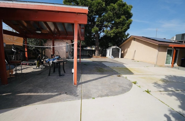 view of patio featuring a shed, central AC, and ceiling fan