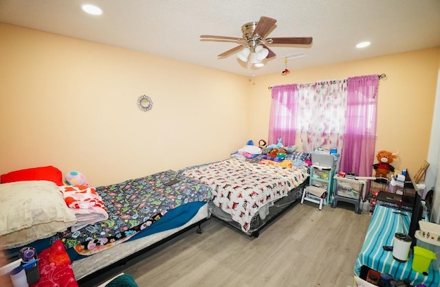 bedroom with hardwood / wood-style flooring and ceiling fan