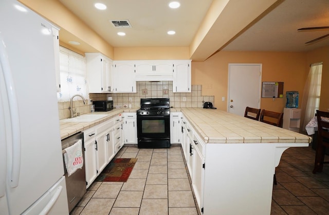 kitchen with black range with gas cooktop, white cabinetry, kitchen peninsula, dishwasher, and white fridge