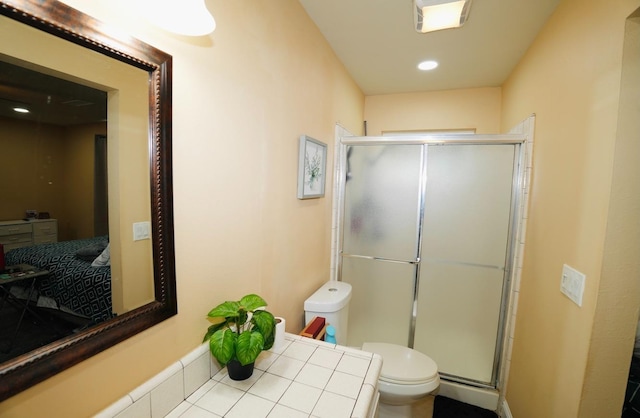 bathroom featuring toilet and a shower with door