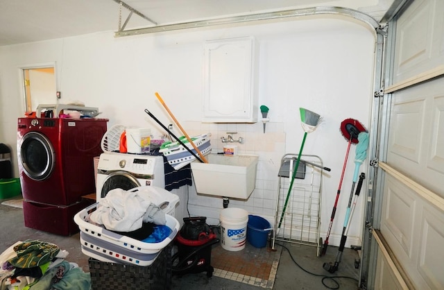 garage featuring sink and washer and dryer