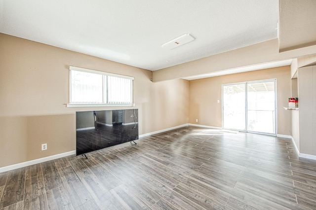 unfurnished living room featuring wood-type flooring