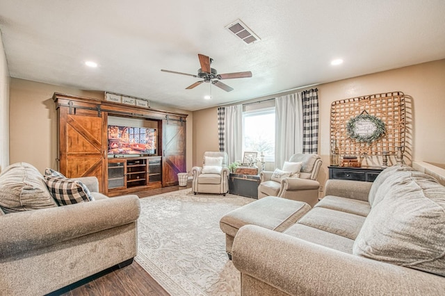 cinema with hardwood / wood-style flooring and ceiling fan