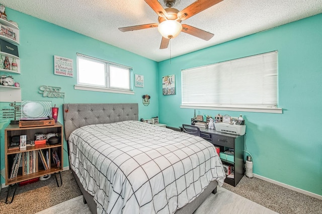 bedroom featuring ceiling fan and a textured ceiling