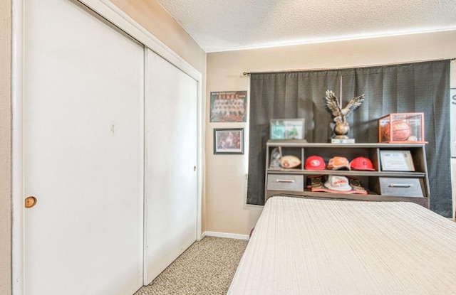 carpeted bedroom featuring a closet and a textured ceiling