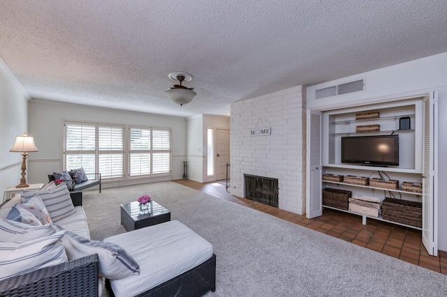 living area featuring visible vents, a fireplace, a textured ceiling, and carpet flooring