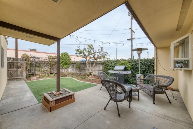 view of patio with a grill and fence