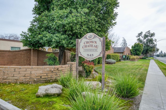 community / neighborhood sign with fence