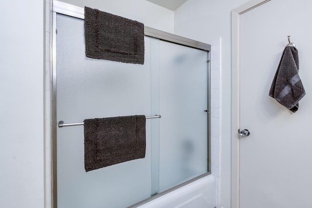 bathroom featuring shower / bath combination with glass door