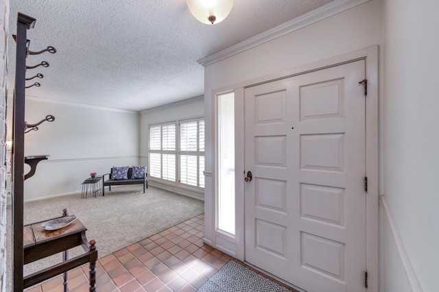foyer with carpet, a textured ceiling, and ornamental molding