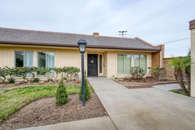 single story home with roof with shingles