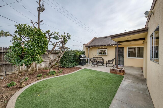 view of yard with outdoor lounge area, a fenced backyard, and a patio