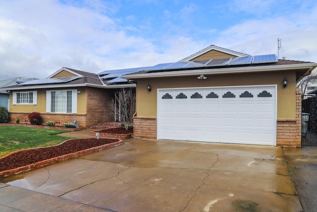 view of front facade featuring a garage and solar panels