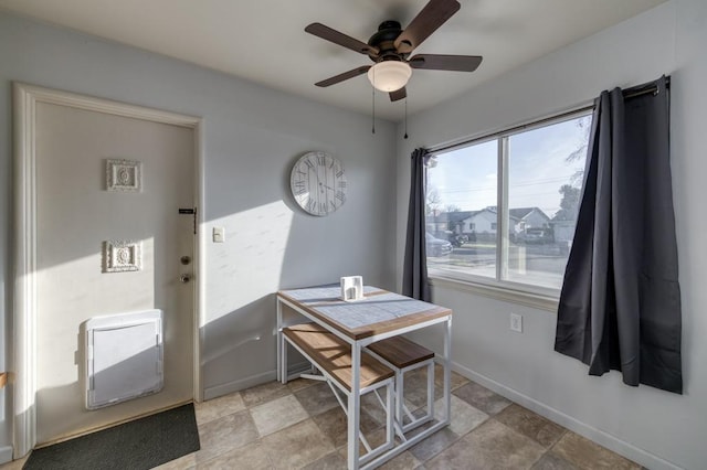 dining room with heating unit and ceiling fan