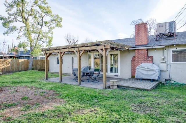 back of house featuring central AC unit, a yard, a pergola, and a wooden deck