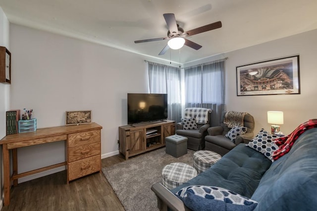 living room featuring dark wood-type flooring and ceiling fan