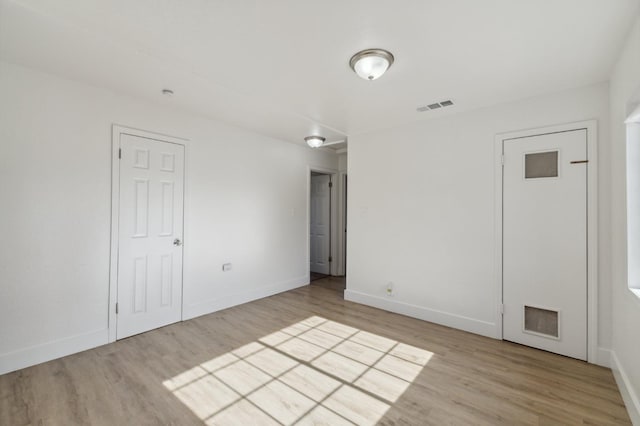 unfurnished room featuring light hardwood / wood-style floors