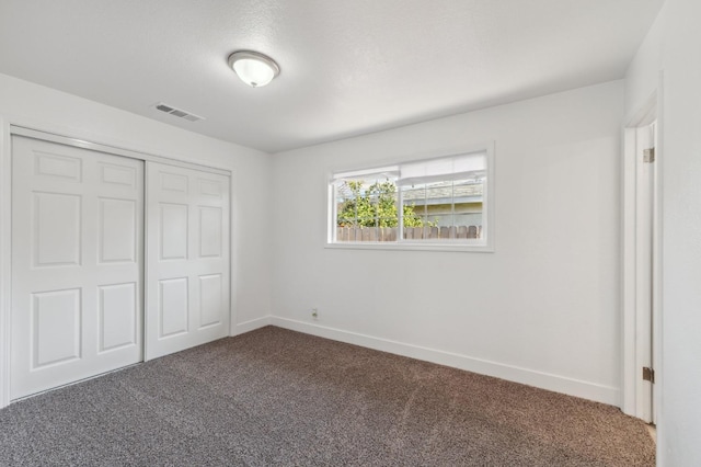 unfurnished bedroom featuring a closet and carpet flooring