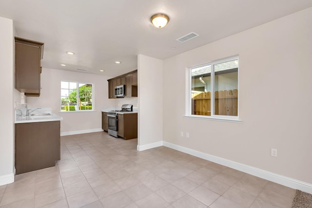 208 E Florence Ave, Fresno, CA 93706 - kitchen with a sink, visible vents, light countertops, baseboards, and appliances with stainless steel finishes