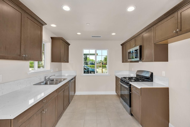 208 E Florence Ave, Fresno, CA 93706 - kitchen with appliances with stainless steel finishes, plenty of natural light, baseboards, and a sink
