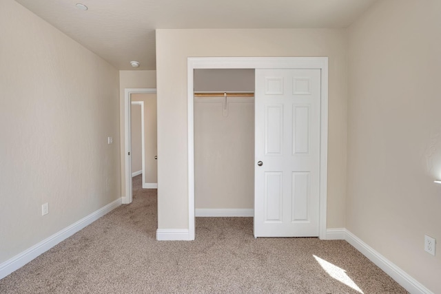 208 E Florence Ave, Fresno, CA 93706 - unfurnished bedroom with baseboards, carpet flooring, and a closet