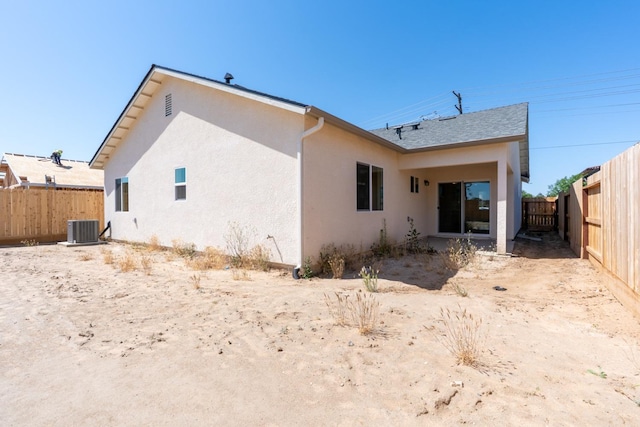 208 E Florence Ave, Fresno, CA 93706 - back of property with cooling unit, stucco siding, roof with shingles, and a fenced backyard