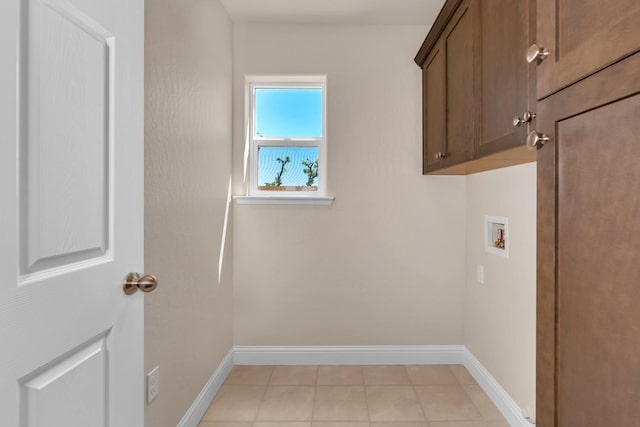 208 E Florence Ave, Fresno, CA 93706 - clothes washing area featuring cabinet space, washer hookup, light tile patterned floors, and baseboards