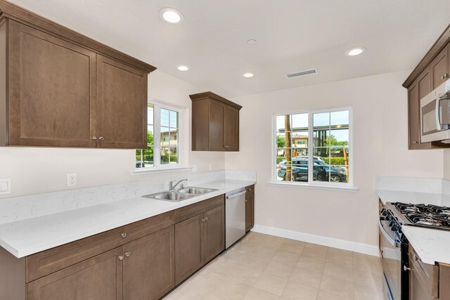 208 E Florence Ave, Fresno, CA 93706 - kitchen featuring stainless steel dishwasher, visible vents, baseboards, white microwave, and gas stove