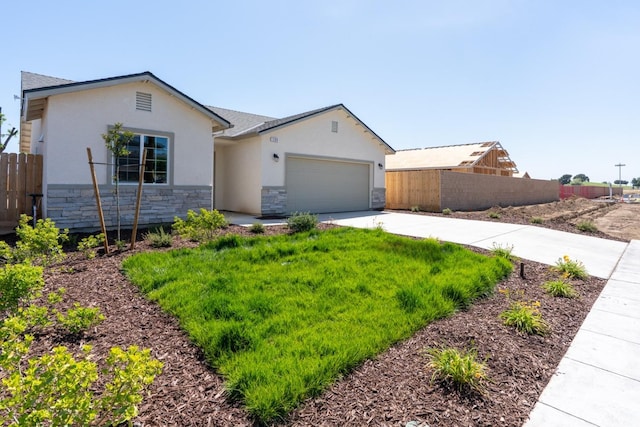 208 E Florence Ave, Fresno, CA 93706 - ranch-style house featuring stone siding, stucco siding, driveway, and fence