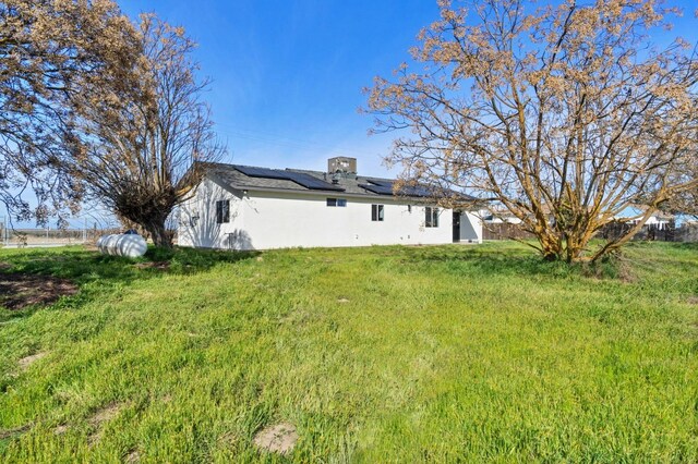 rear view of property featuring a yard