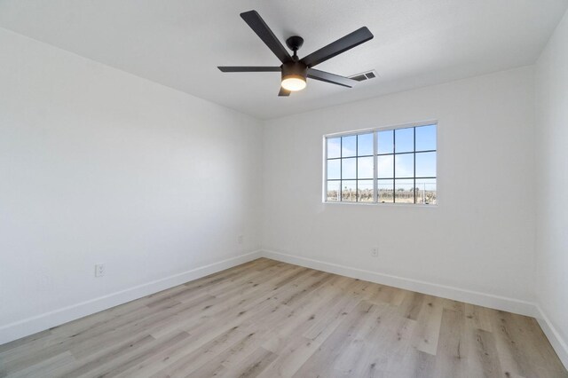 spare room with ceiling fan and light hardwood / wood-style flooring