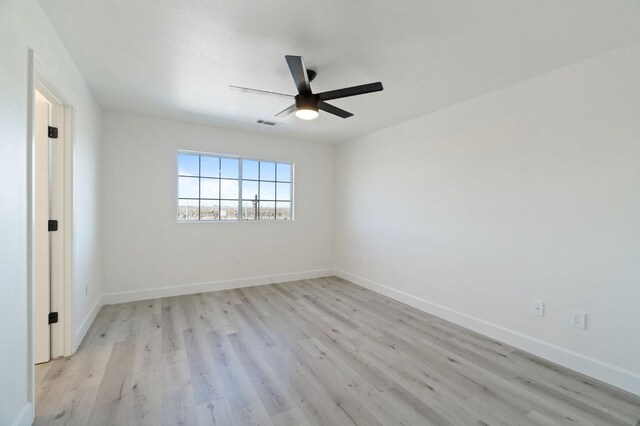 empty room featuring ceiling fan and light hardwood / wood-style flooring