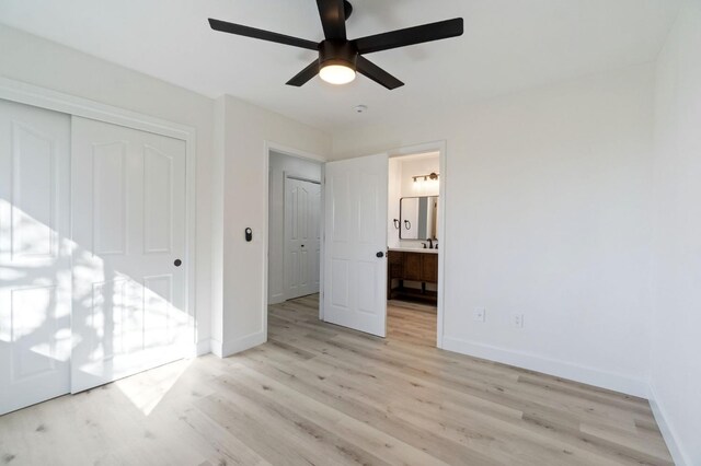 unfurnished bedroom with ceiling fan, light hardwood / wood-style flooring, connected bathroom, and a closet