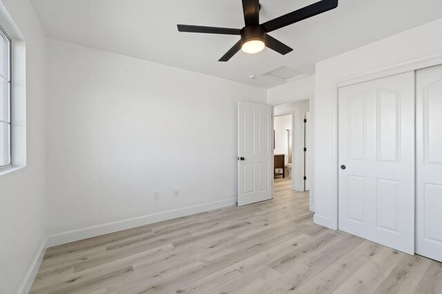 unfurnished bedroom featuring light wood-type flooring, a closet, and ceiling fan