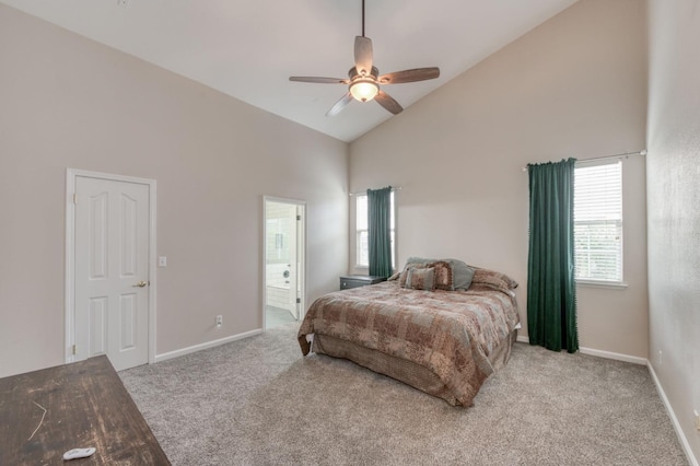 carpeted bedroom featuring ceiling fan, high vaulted ceiling, and ensuite bath