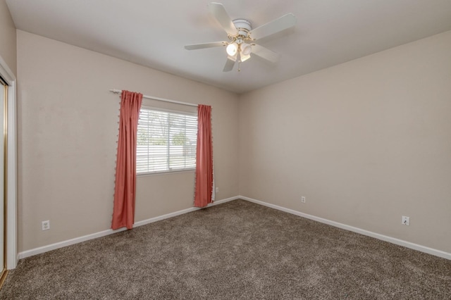 empty room with ceiling fan and carpet floors