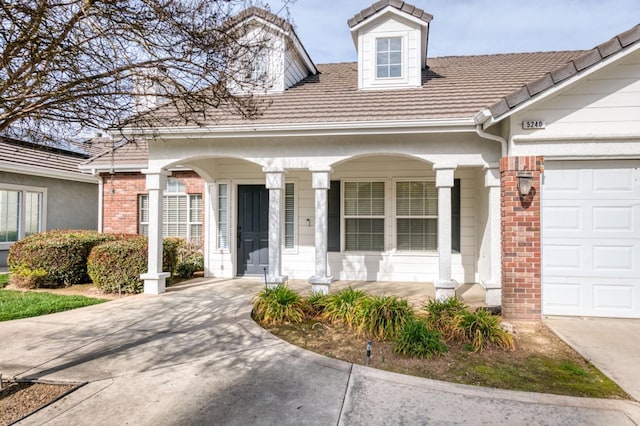 view of front of property featuring a garage and a porch