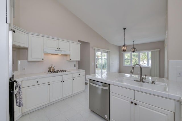 kitchen with white cabinetry, dishwasher, and tile countertops