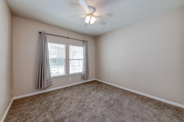 carpeted empty room featuring ceiling fan